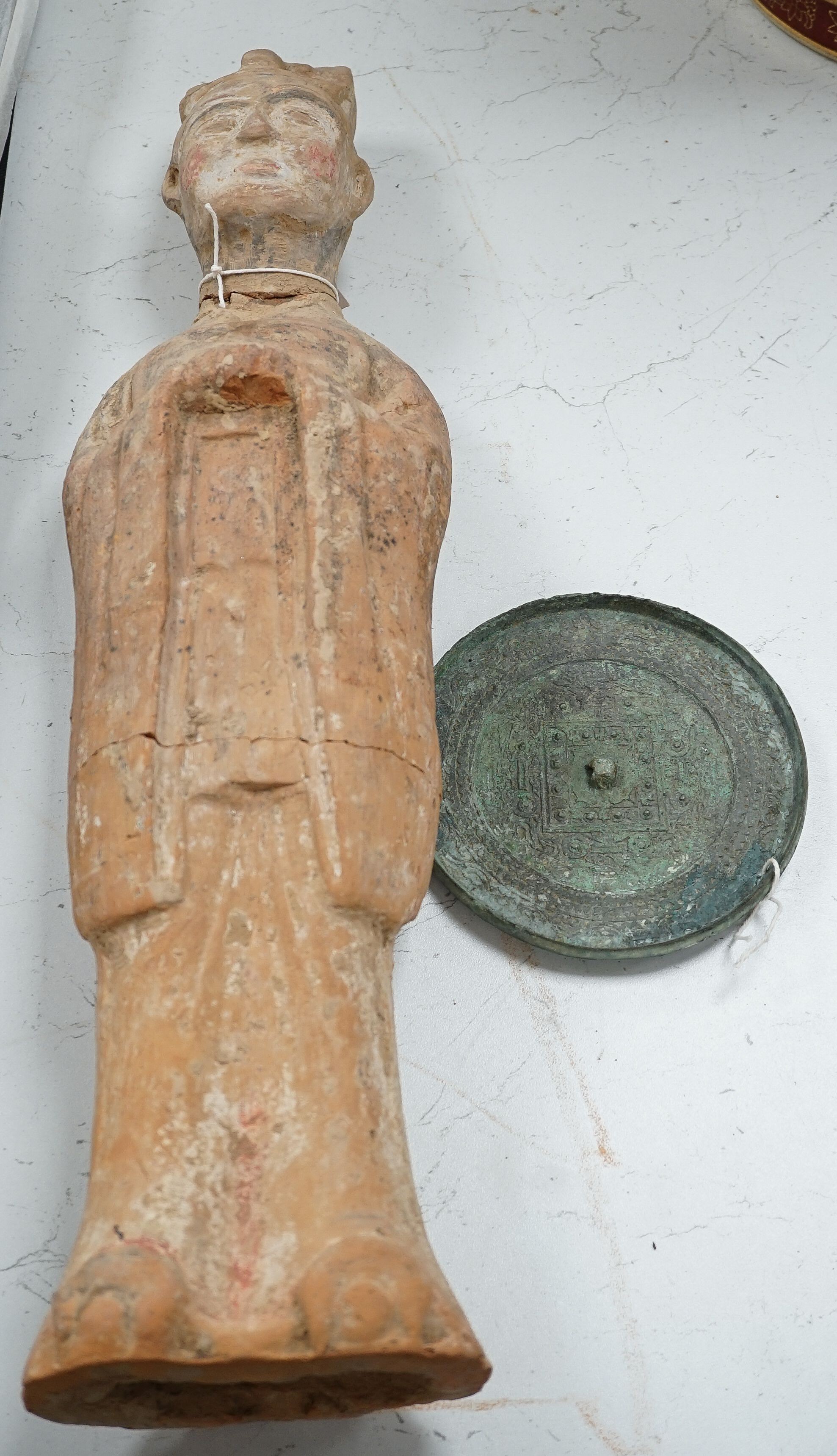 A large Tang Dynasty standing figure, height 57cm, and a Han dynasty bronze mirror, damage